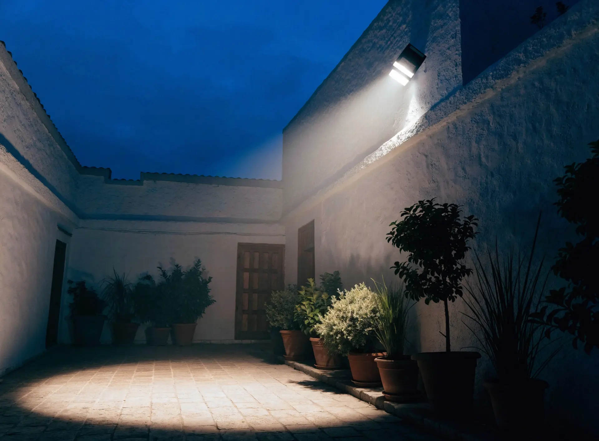 Projecteur solaire éclairant une cour intérieure la nuit